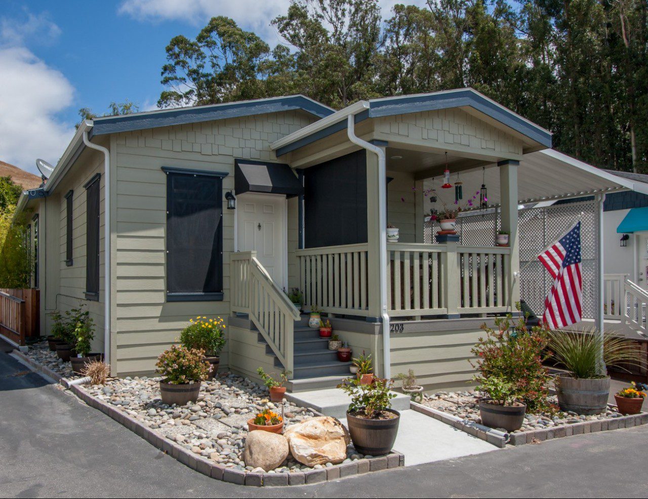  A beige manufactured home with a US flag outside